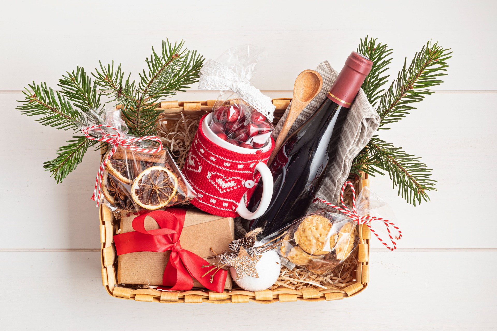 Refined Christmas gift basket for culinary enthusiats with bottle of wine and mulled wine ingredients