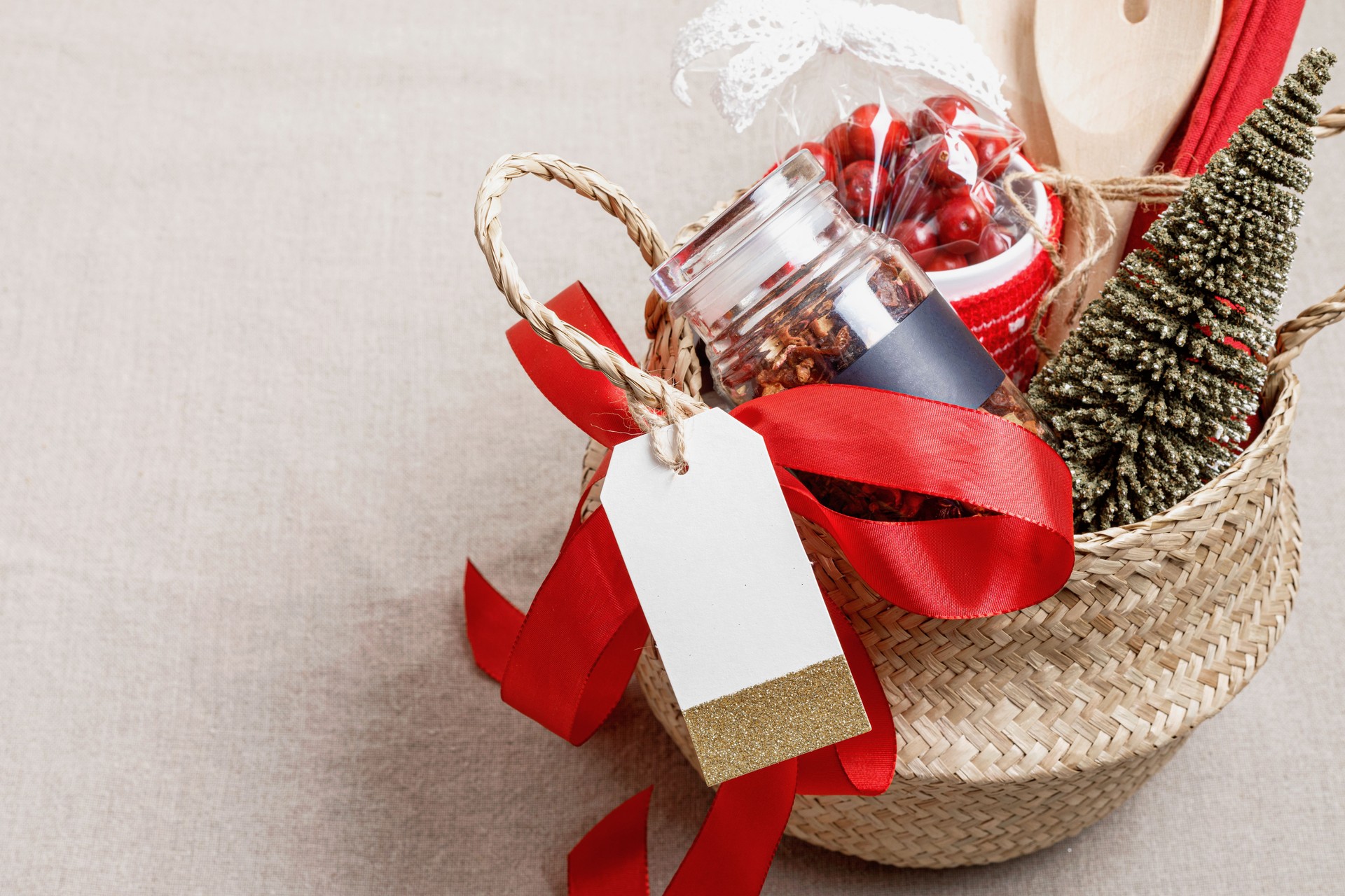 Refined Christmas gift basket for culinary enthusiats with bottle of oil, vinegar and kitchen utensils